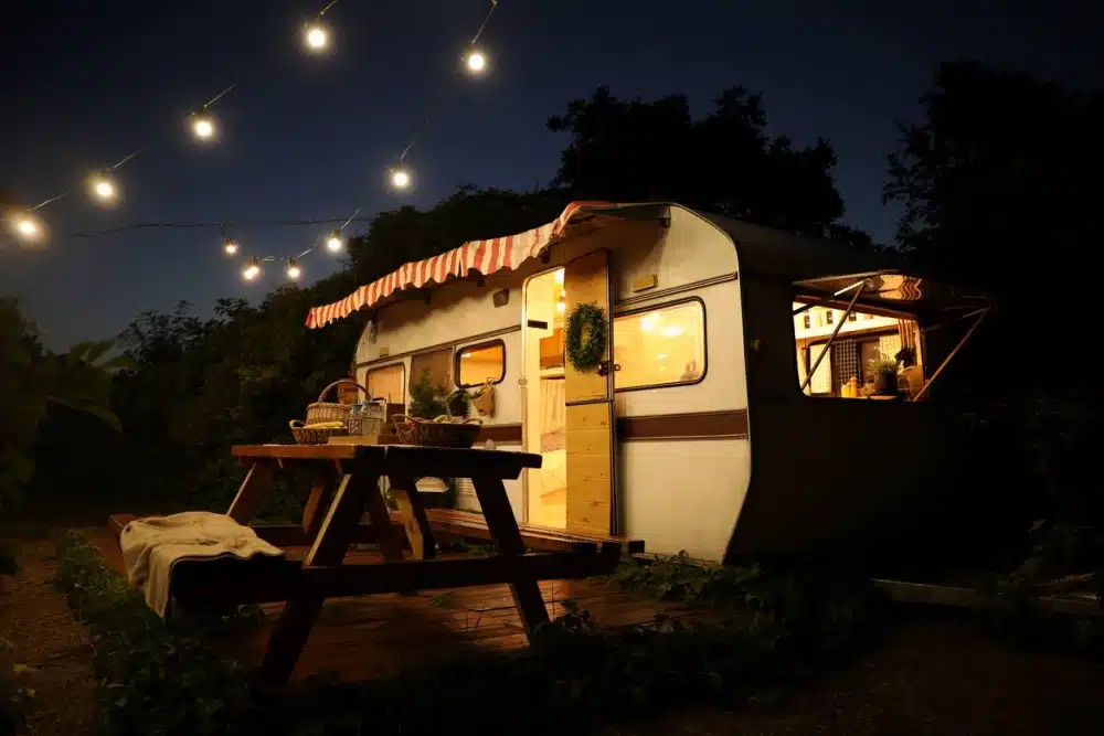 RV at night with lights and table out front