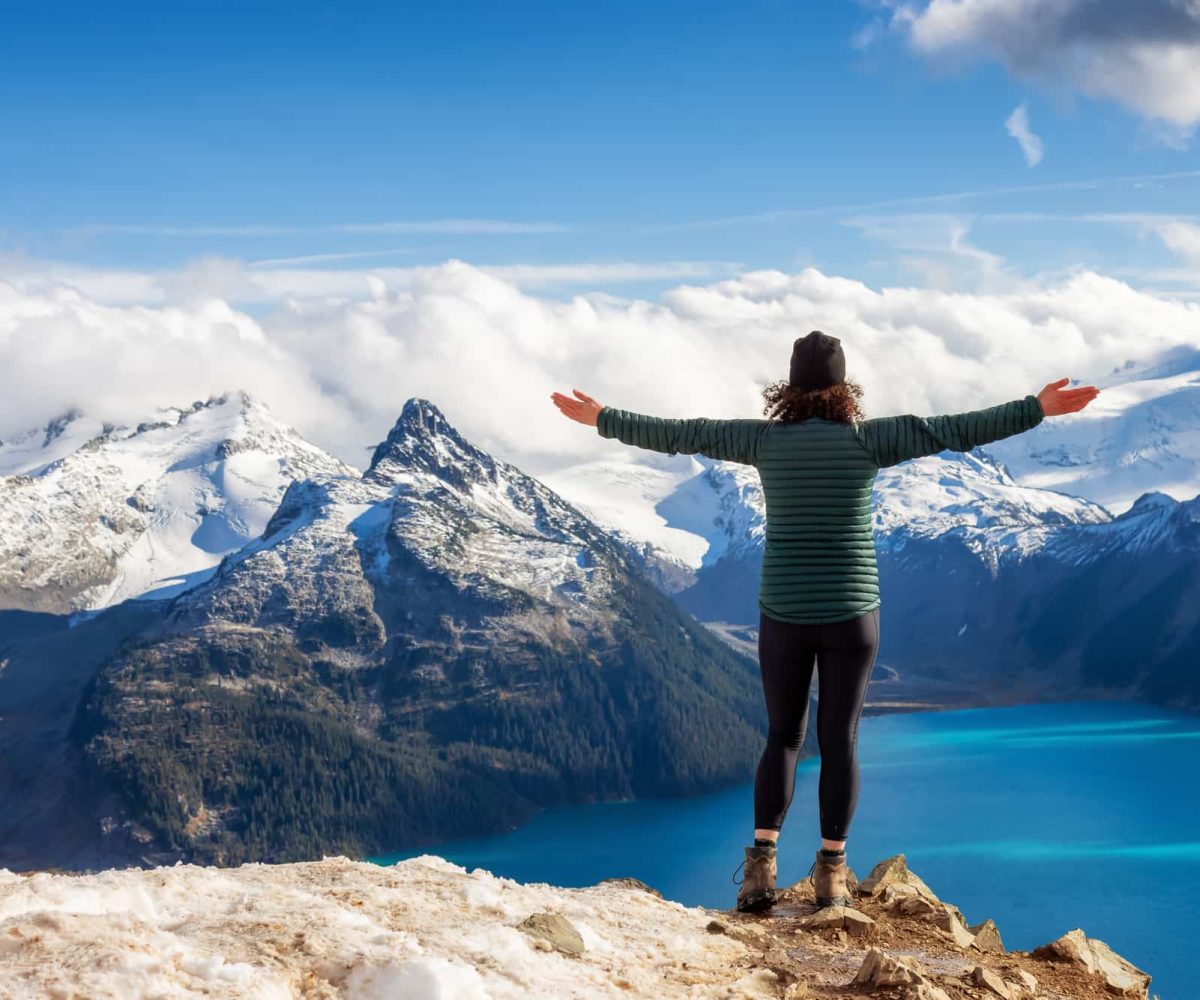 A hiker enjoying the views from the top of a breathtaking mountain landscape.