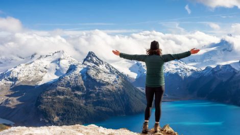 A hiker enjoying the views from the top of a breathtaking mountain landscape.