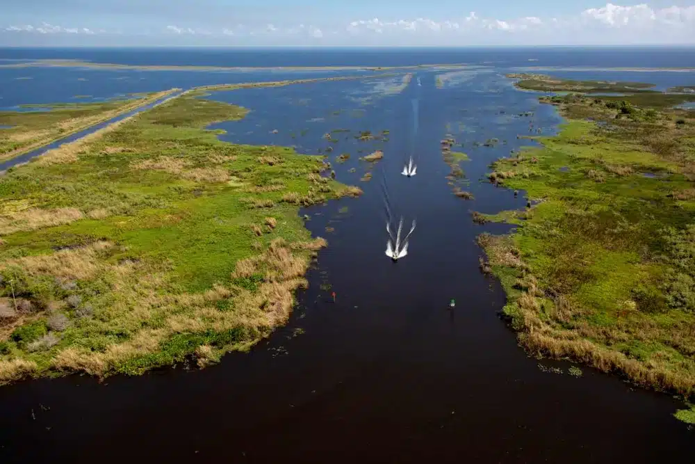 A pair of boats speeding down Lake Okeechobee
