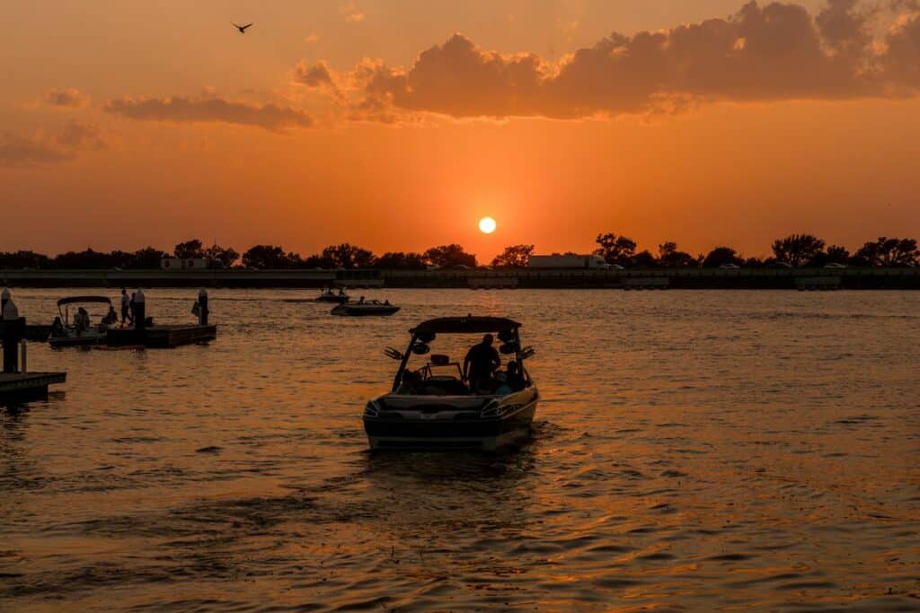 The sun sets as anglers and boaters ride Texasโ Rockwall Harbor.