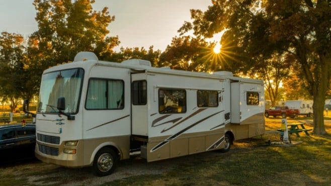 rv parked in a grassy area, prepared for a height measurement