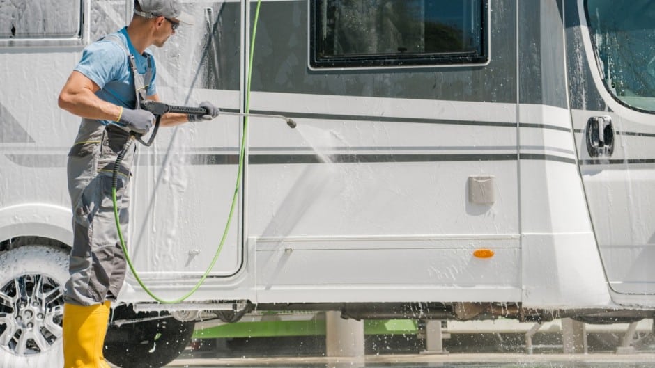 man cleaning his rv to protect and store it