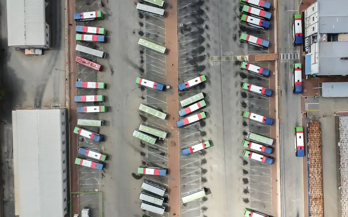 Aerial view of a truck parking lot with colorful trucks parked diagonally.