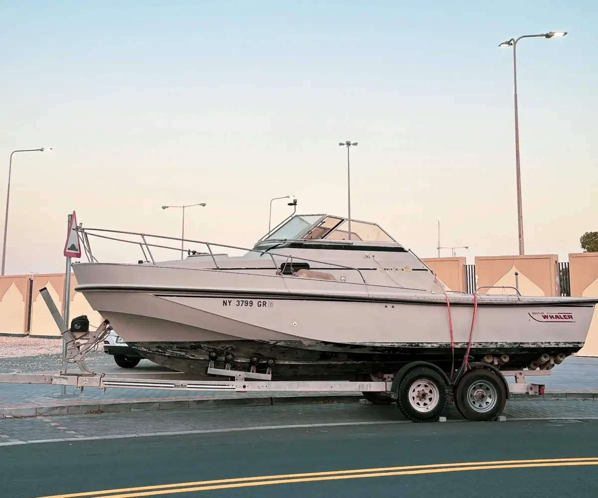 Boat on a trailer stored on the street.