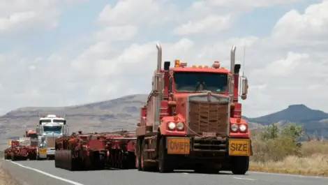 Trucks driving on a highway.