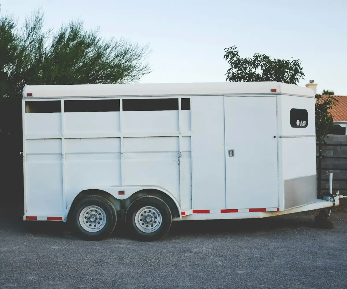 White trailer parked in a driveway, showing secure home trailer storage options.