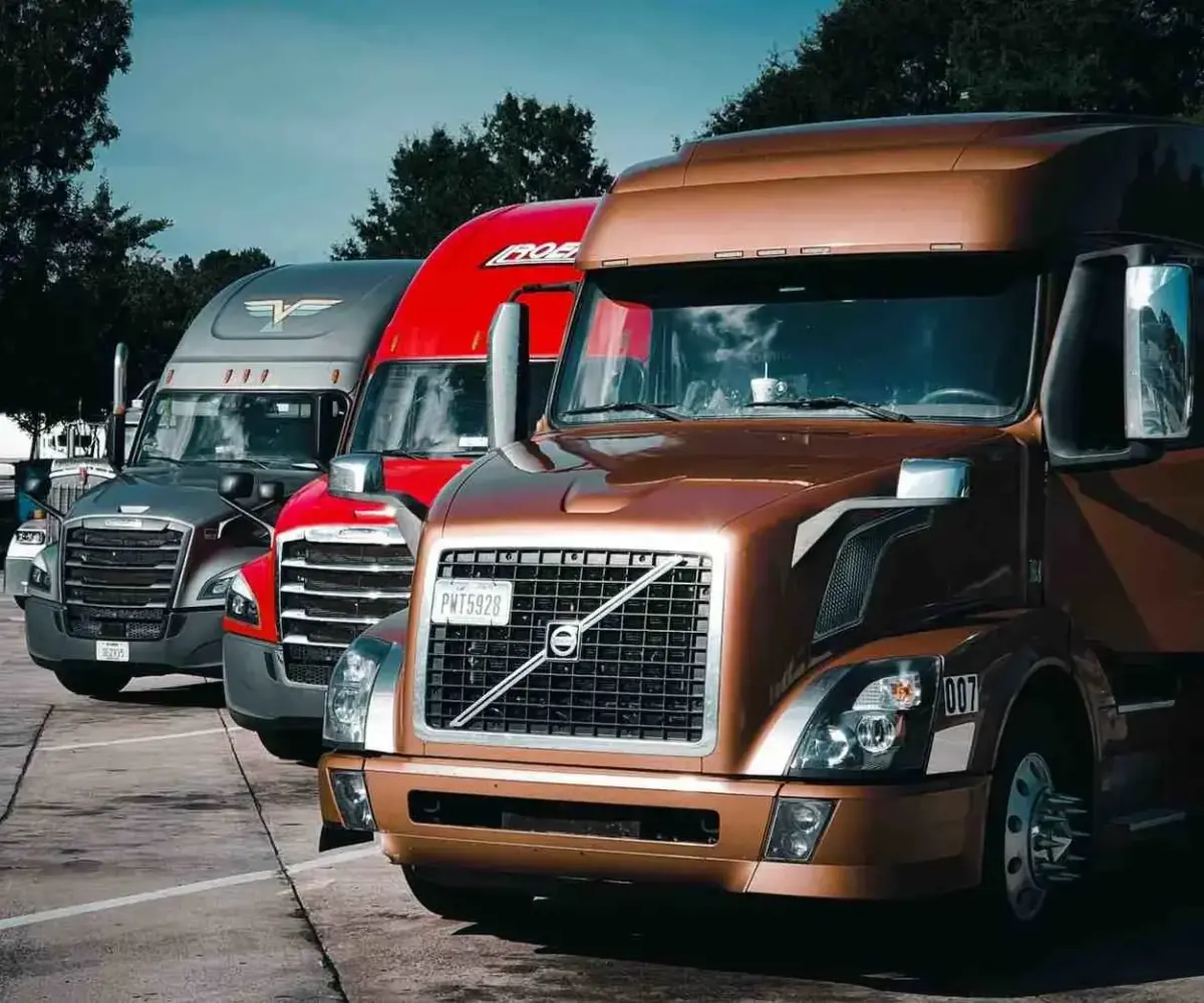 Different types of truck carriers parked in a lot.