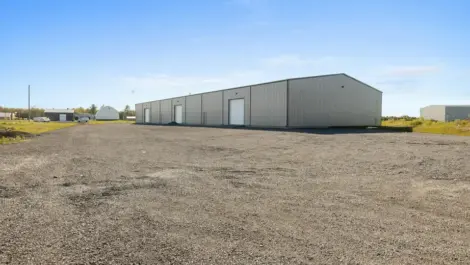 Gravel-paved industrial outdoor storage yard.