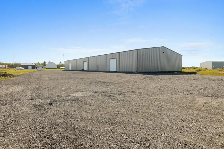Gravel-paved industrial outdoor storage yard.