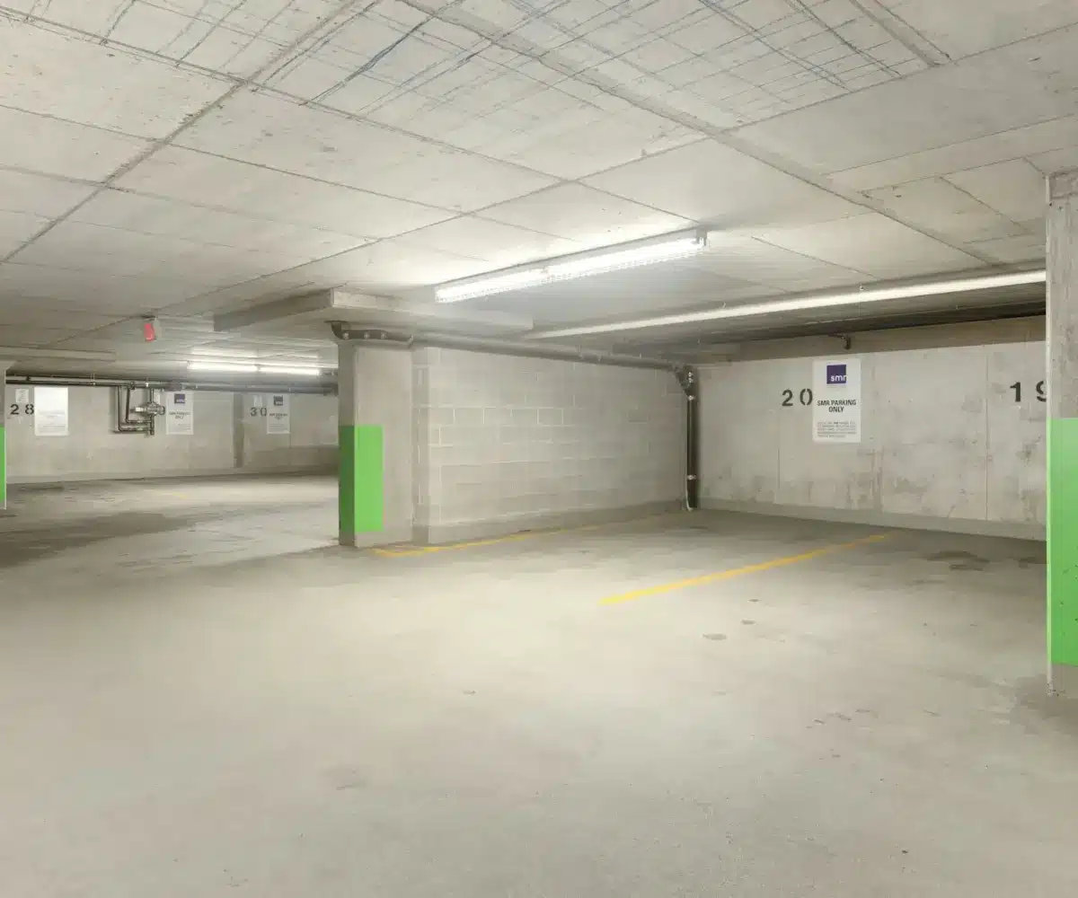Underground concrete parking garage with marked parking bays