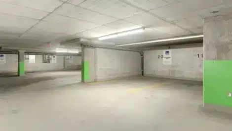 Underground concrete parking garage with marked parking bays