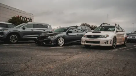 Cars parked in a lot outside Macy’s on a cloudy day.