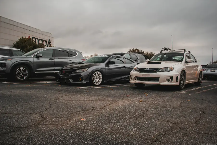 Cars parked in a lot outside Macy’s on a cloudy day.