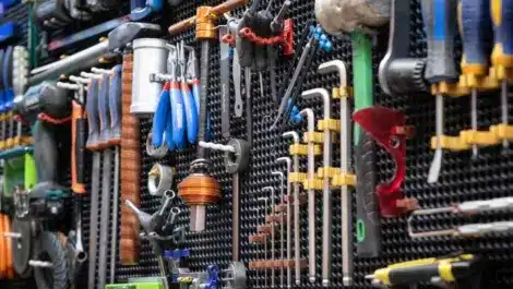 Different hand tools neatly arranged on a tool wall