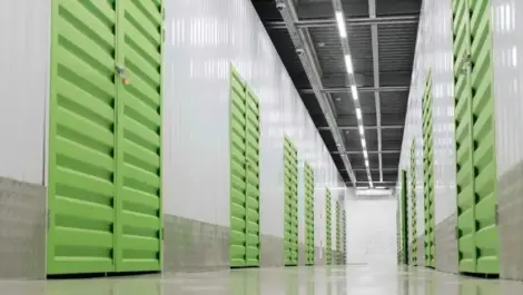 indoor hallway with green storage unit doors