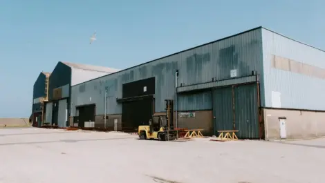 Large industrial warehouse with outdoor storage.