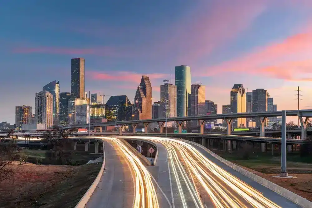 Long-exposure photograph of the highway leading into downtown Houston, TX.