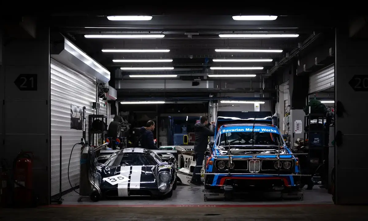 Classic race cars stored inside professional indoor vehicle storage facility.