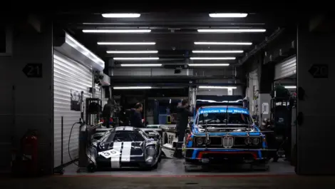 Classic race cars stored inside professional indoor vehicle storage facility.