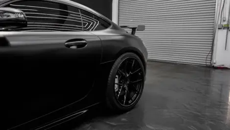 Car parked inside a storage facility, illustrating indoor vehicle storage for cars and other personal vehicles.