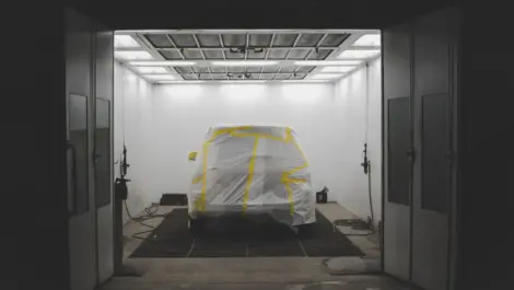 Car covered inside professional paint booth
