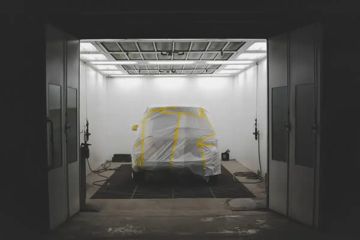 Car covered inside professional paint booth