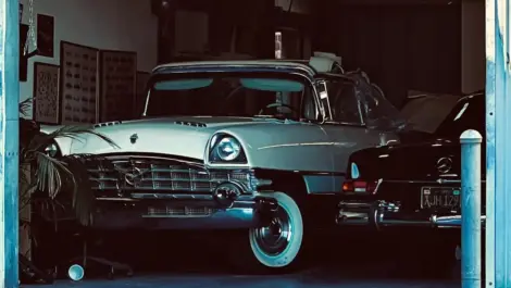 Classic vintage car parked inside a dimly lit garage