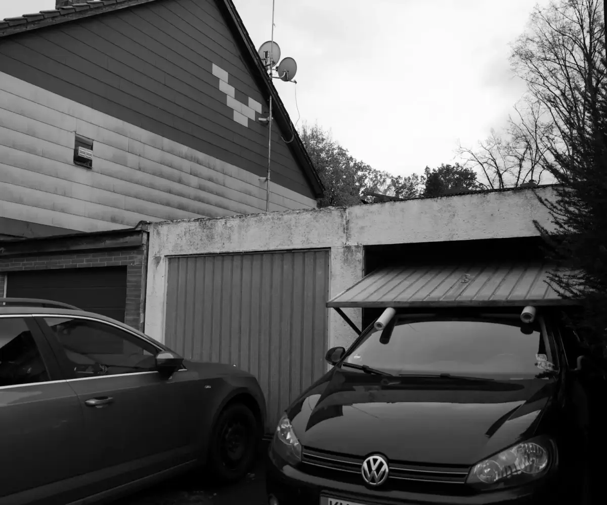Cars parked in residential garage area.