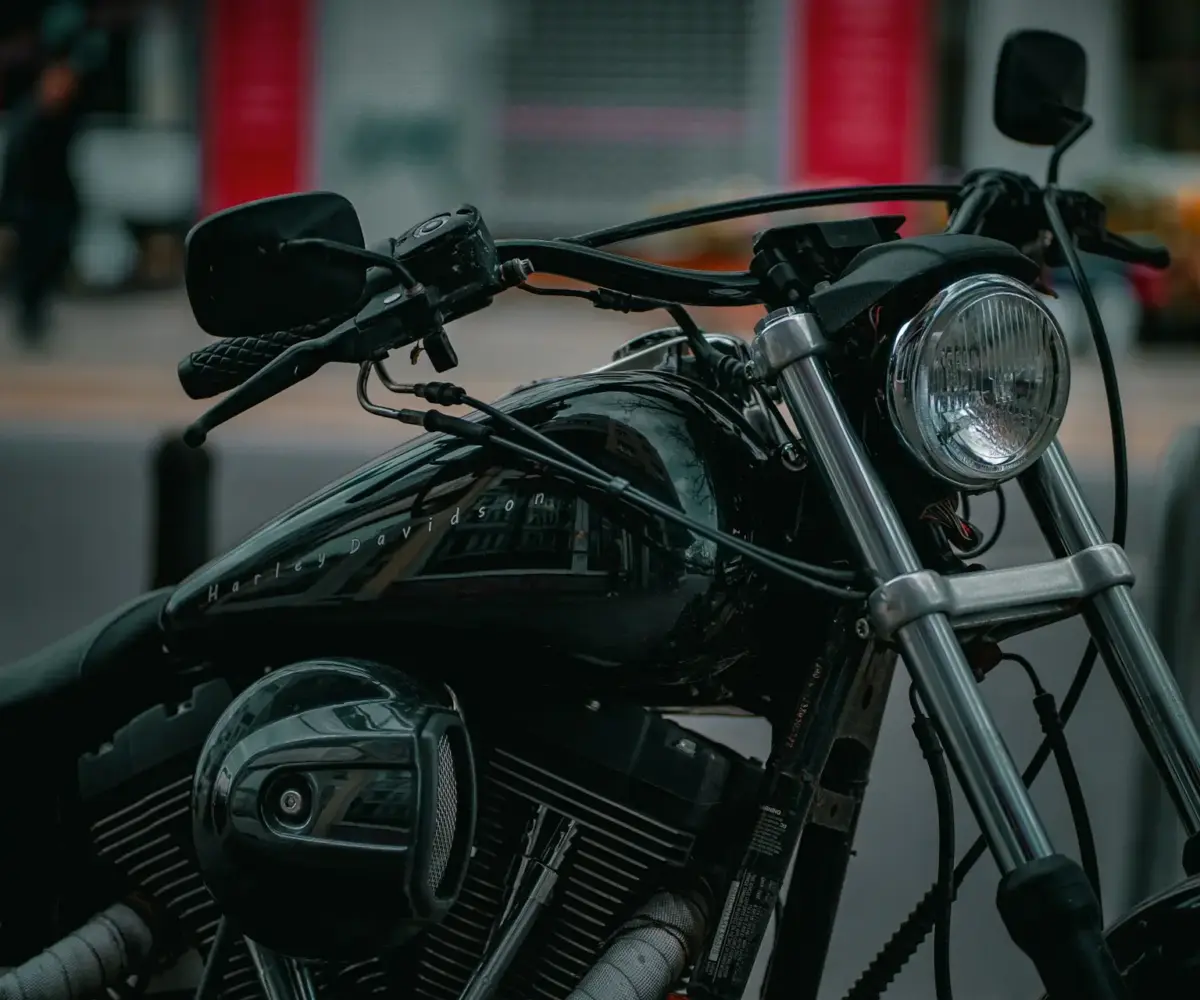 Close-up of a parked motorcycle in an urban setting, illustrating long periods without riding and storage considerations.