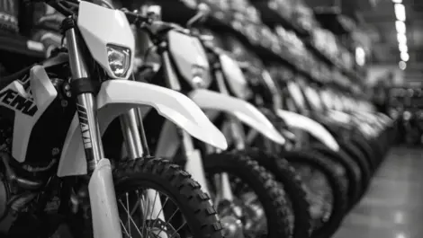 Motorcycles lined up in indoor storage, highlighting protected environments that prevent moisture damage, theft, and long-term wear.