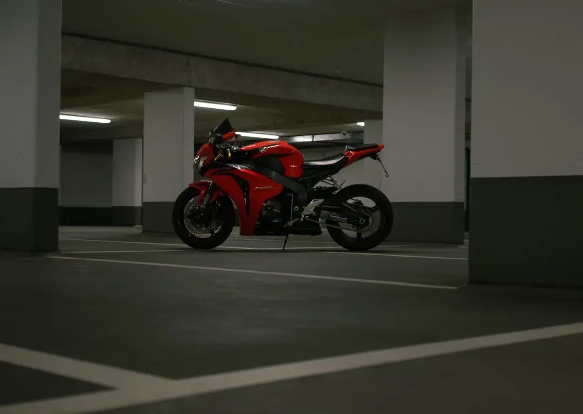 Motorcycle parked in a covered parking garage, illustrating storage conditions where ownership status and access rights may affect use.