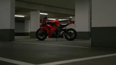Motorcycle parked in a covered parking garage, illustrating storage conditions where ownership status and access rights may affect use.