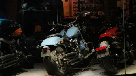 Motorcycles stored indoors in a garage, illustrating fuel system care and proper storage setup during long-term downtime.
