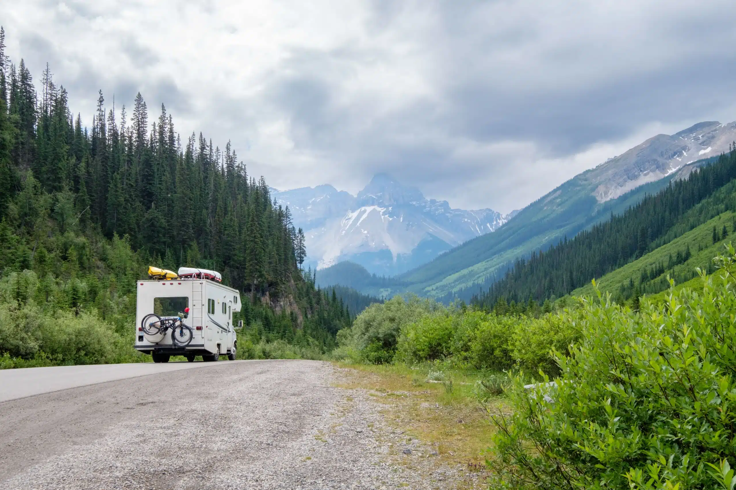 Motorhome traveling through a mountain landscape, representing the type of RV that requires insurance coverage based on vehicle class, usage, and storage.
